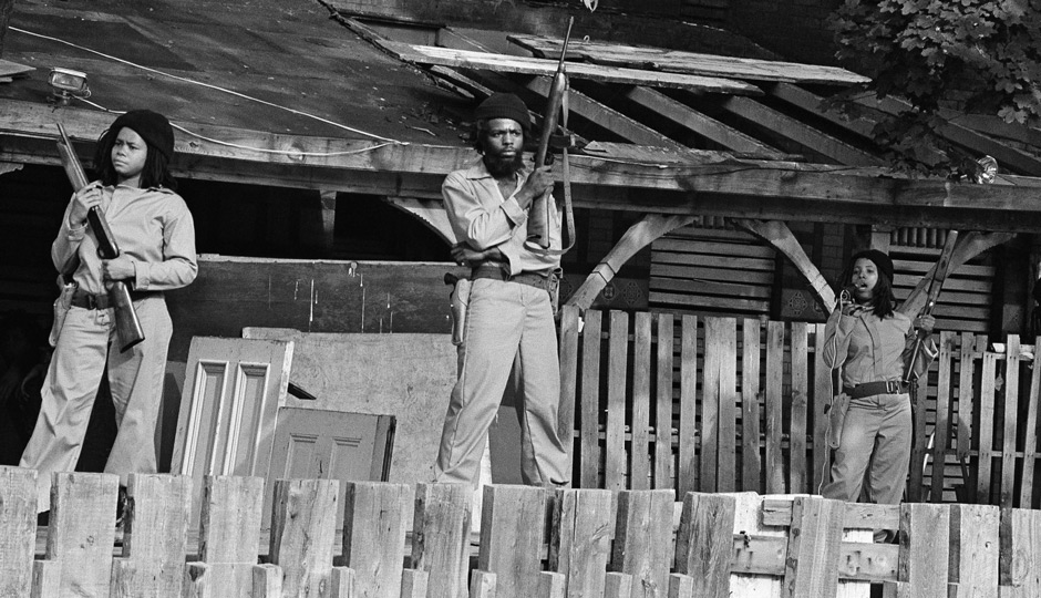 MOVE members with sawed-off shotguns and automatic weapons at the Powelton house in 1977: AP Photo