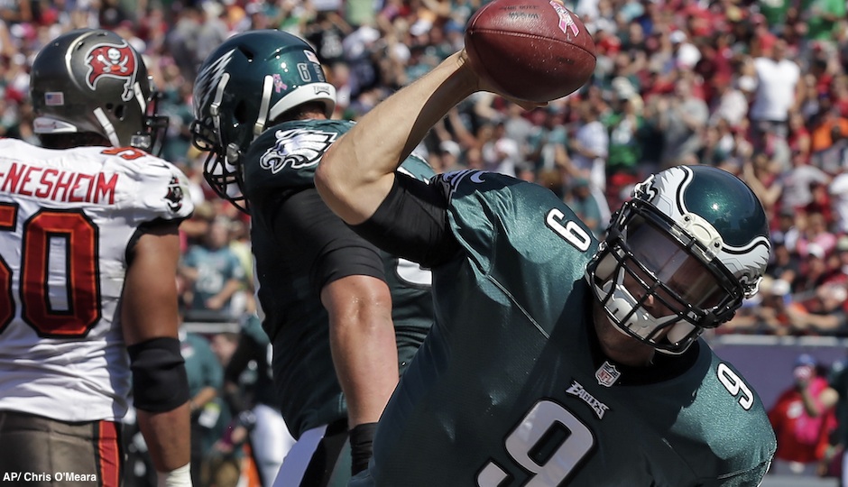 Philadelphia Eagles quarterback Nick Foles (9) spikes the football after scoring on a four-yard touchdown run during the first quarter of an NFL football game against the Tampa Bay Buccaneers Sunday, Oct. 13, 2013, in Tampa, Fla. (AP Photo/Chris O'Meara)