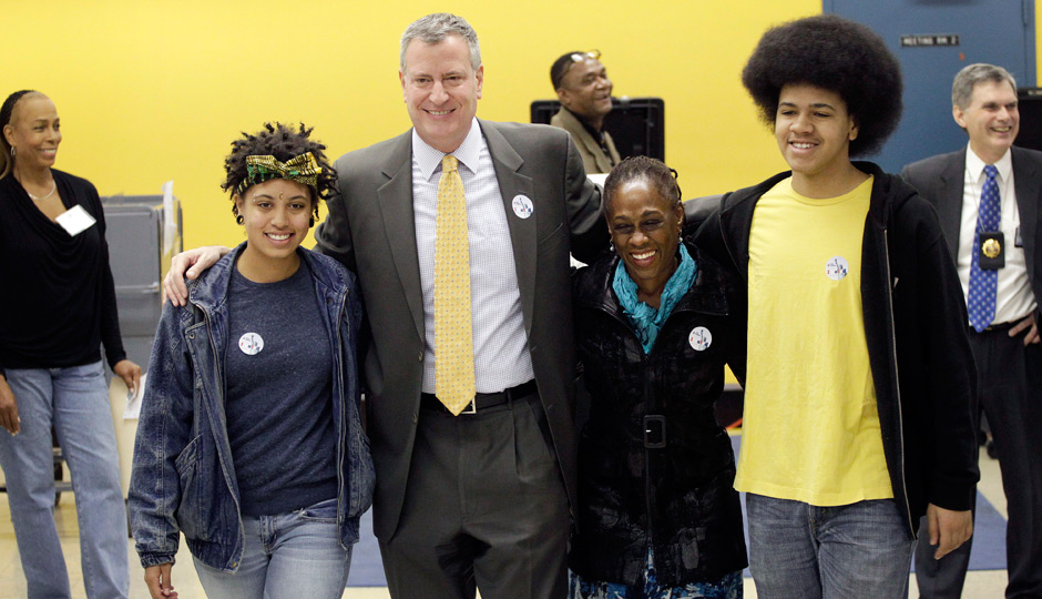 Democratic mayoral candidate Bill de Blasio embraces his family as they exit a polling station, Tuesday, Nov. 5, 2013 in the Park Slope neighborhood of the Brooklyn borough of New York. De Blasio is running against Republican candidate Joseph Lhota. From left, daughter, Chiara, de Blasio, wife Chirlane McCray and son, Dante. (AP Photo/Mark Lennihan)