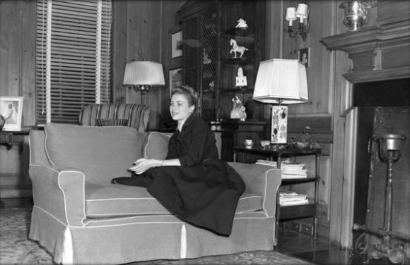 Grace sitting on a couch in her parents' East Falls home in 1954