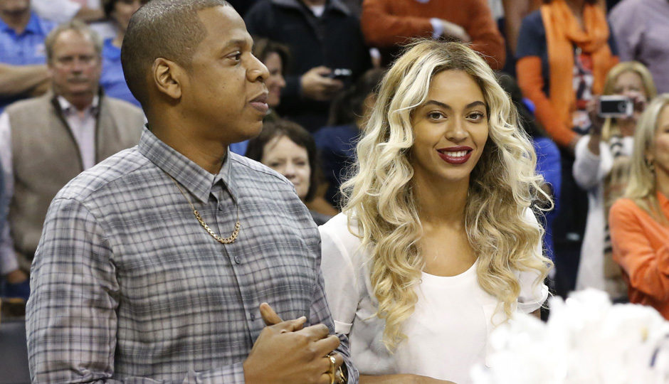 Jay-Z and Beyonce before the start of an NBA basketball game between the Oklahoma City Thunder and the Los Angeles Clippers in Oklahoma City on Nov. 21. (AP Photo/Sue Ogrocki)