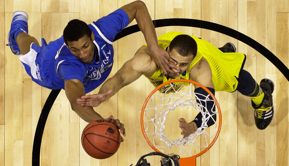 Kentucky's Marcus Lee, left, and Michigan's Jordan Morgan go after a rebound during the first half of an NCAA Midwest Regional final college basketball tournament game Sunday, March 30, 2014, in Indianapolis. Photo | Michael Conroy, Associated Press