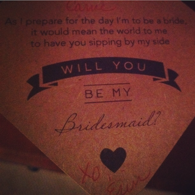 The "Will you be my bridesmaid?" tag attached to my wine glass by my friend. 
