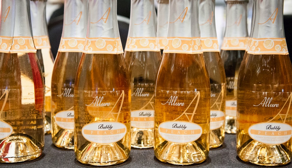 Mini bottles of peach bubbly greeted guests as they entered the event. Photo by Christina Lee for Ashley Lynn Fry Photography. 