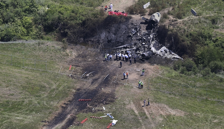 This aerial photo from Monday, June 2, shows wreckage from where a plane plunged down and erupted in flames during a takeoff attempt at Hanscom Field on Saturday night in Bedford, Mass. (AP Photo/The Boston Globe, David L. Ryan) 