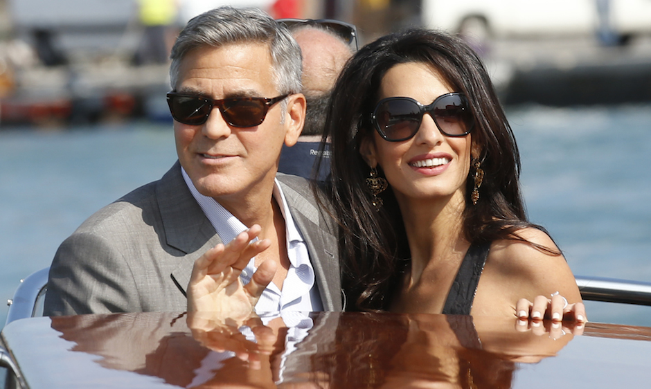 George Clooney, left, and Amal Alamuddin arrive in Venice, Italy, Friday, Sept. 26, 2014. Clooney, 53, and Alamuddin, 36, are expected to get married this weekend in Venice, one of the world’s most romantic settings. (AP Photo/Luca Bruno)