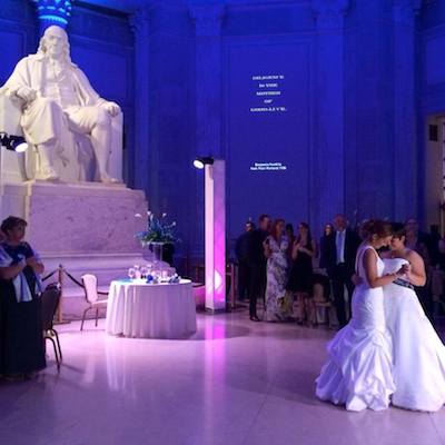 Lauren and Melissa dancing under a statue of Benjamin Franklin. | Photo fro Facebook