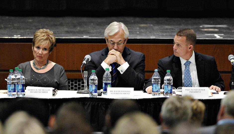 Central Bucks School Board Member Geryld McMullen (left), Dr. David Weitzel, Superintendent for Central Bucks School District (middle) and Paul Faulner, School Board President listen to public comment on the recent hazing scandal which caused the cancellation of the 2014 football season with two games left.