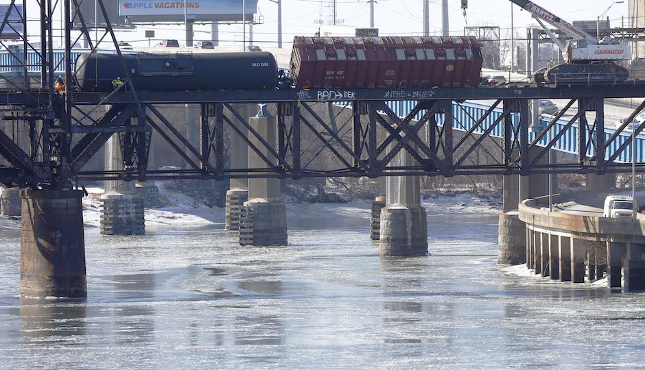 Railroad crews work on one of five derailed tank cars on a bridge over the Schuylkill River, January in Philadelphia. The accident Monday followed a series of derailments involving Bakken Shale crude from North Dakota including one that exploded in Canada, killing 47 people. (AP Photo/Matt Rourke)