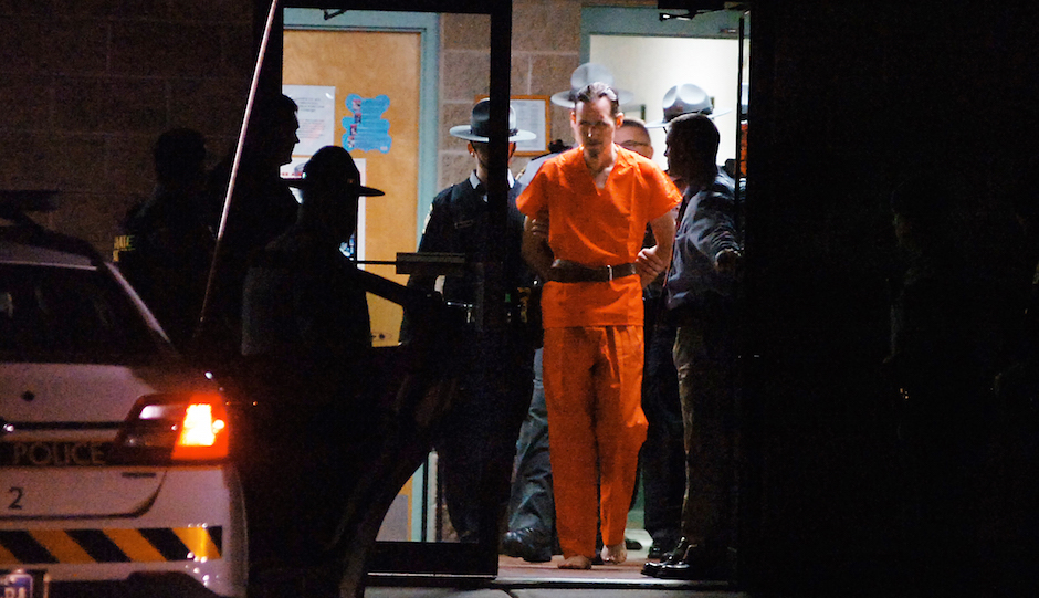Pennsylvania State Police Troopers take away suspected killer Eric Frein from the Blooming Grove State Police barracks early Friday, Oct. 31, 2014, in Blooming Grove Township, Pennsylvania.  (AP Photo /The Scranton Times-Tribune, Butch Comegys)