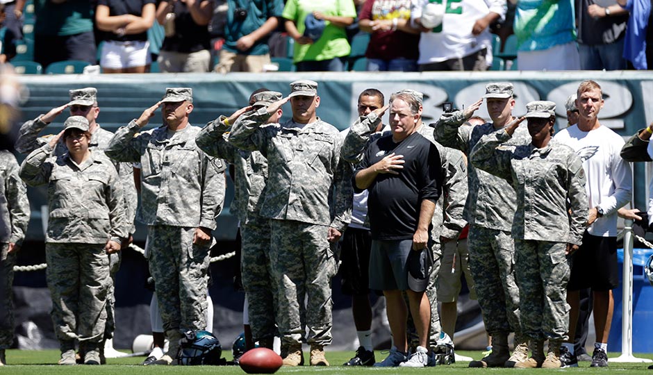 Chip Kelly with service members during the team’s Military Appreciation Day in 2013. Photograph by Matt Rourke, AP