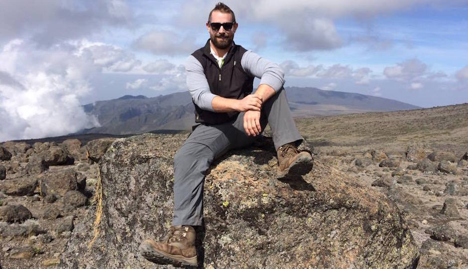 Sims looking rugged and accomplished at the top of Mount Kilimanjaro. | Photo from Facebook.
