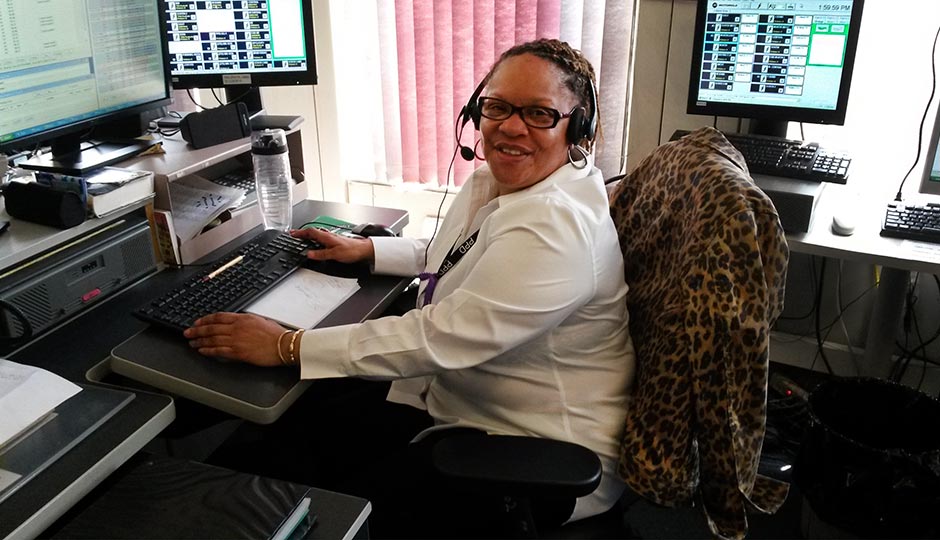 911 dispatcher Celestine Stanford at her desk inside the Police Administration Building, where she takes hundreds of calls each day. Photo | Christine O'Brien, Philadelphia Police Department 