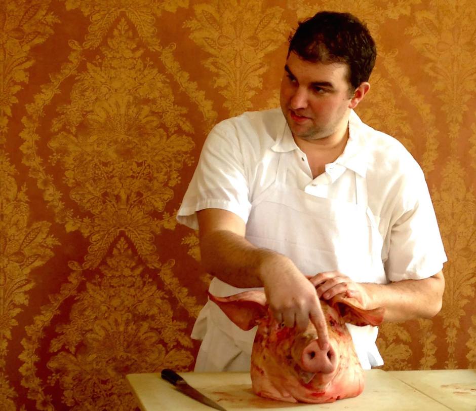 Chef Lawler with a pig's head.