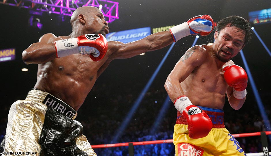 In this May 2, 2015, photo, Floyd Mayweather Jr., left, hits Manny Pacquiao, from the Philippines, during their welterweight title fight in Las Vegas.