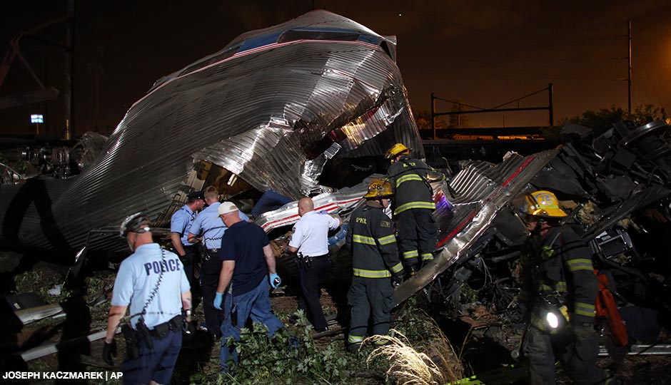 Emergency personnel work the scene of a train wreck, Tuesday, May 12, 2015, in Philadelphia. An Amtrak train headed to New York City derailed and crashed in Philadelphia.  