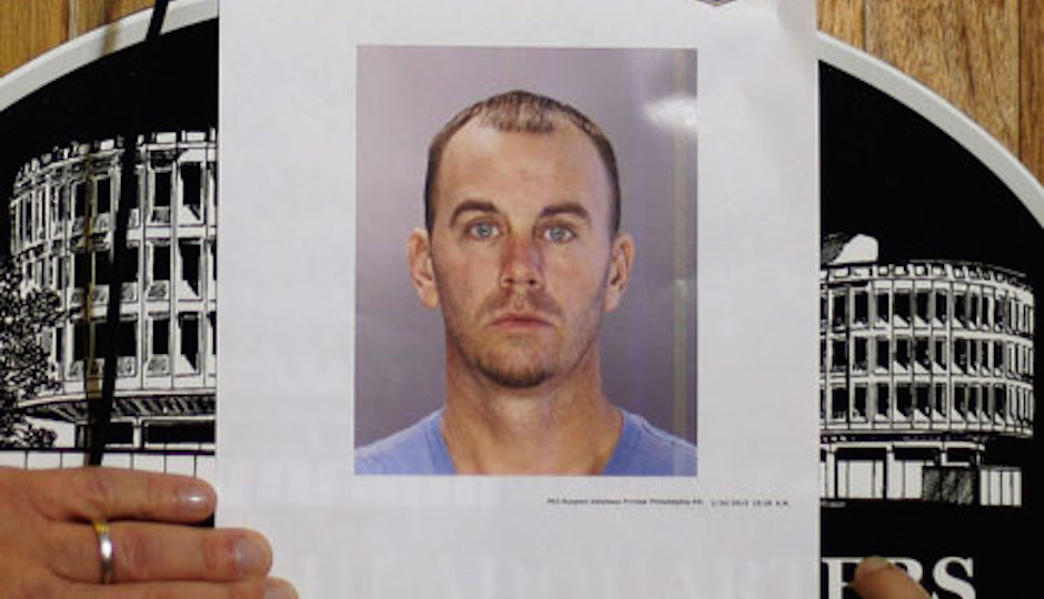Jason Smith's picture is shown to the media during a 2013 press conference about the murder charge he faced. | AP
