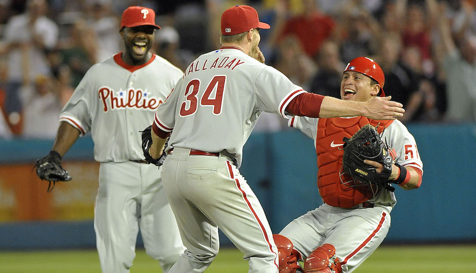 May 29, 2010; Miami, FL, USA; Philadelphia Phillies starting pitcher Roy Halladay (34) celebrates with catcher Carlos Ruiz (51) and Ryan Howard (6) after pitching a perfect game against the Florida Marlins at Sun Life Stadium. Philadelphia Phillies defeated the Marlins 1-0 Mandatory Credit: Steve Mitchell-USA TODAY Sports