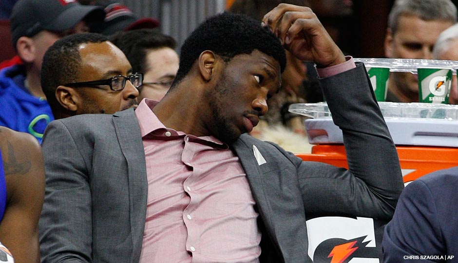Joel Embiid looks on from the sidelines during the January 7, 2015 game between the Milwaukee Bucks and the Philadelphia 76ers at the Wells Fargo Center.
