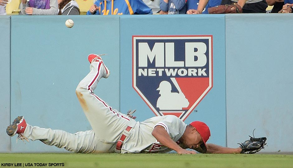 Philadelphia Phillies right fielder Ben Revere is unable to catch a fly ball triple by Los Angeles Dodgers second baseman Howie Kendrick in the first inning of a July 6th game at Dodger Stadium.  