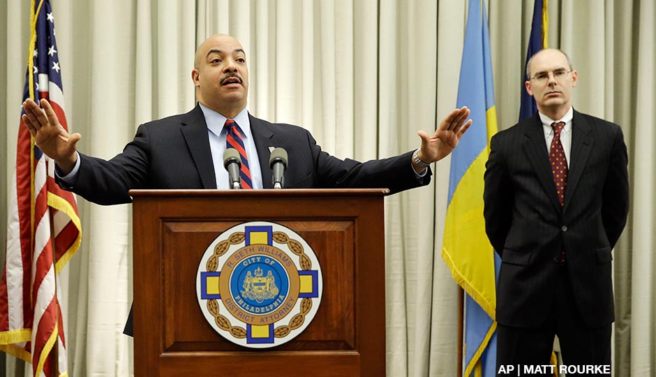 Philadelphia District Attorney Seth Williams, center, accompanied by investigator Frank Fina, speaks during a news conference Monday, Jan. 27, 2014, in Philadelphia. 