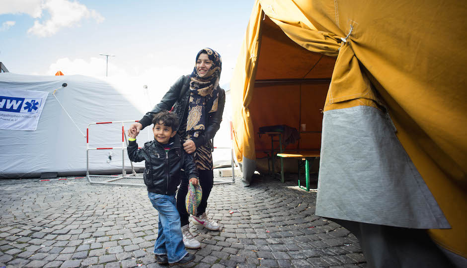 A mother and her child as they arrive in Germany. Thousands of refugees mainly from Iraq and Syria continue to flood in to Munich railway station in southern Germany as trains arrive from Budapest and Vienna. | Photo by Geovien So/NurPhoto