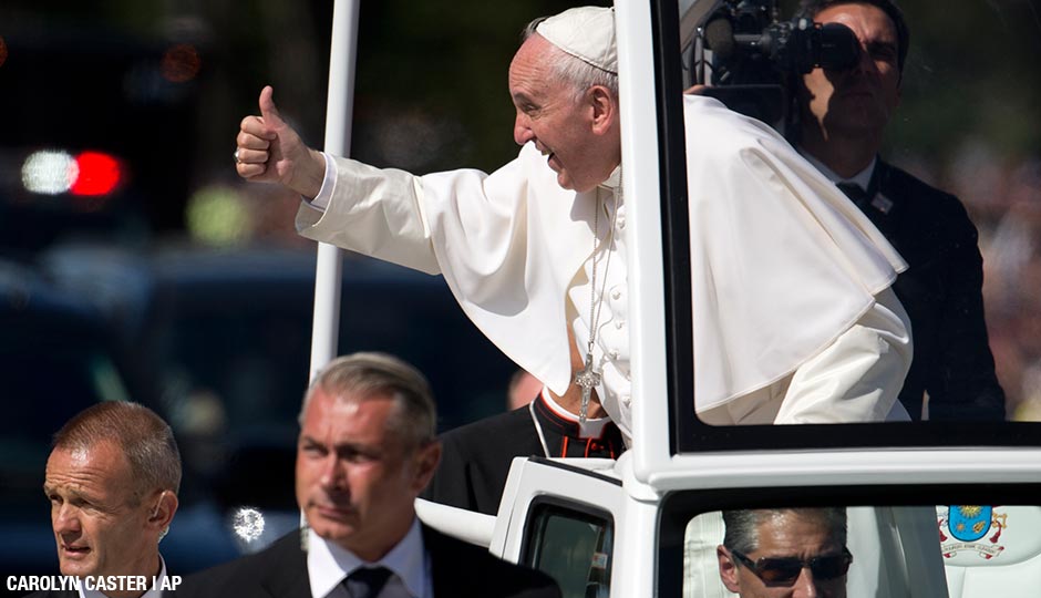 Pope Francis give the thumbs-up from the popemobile during a parade around the Ellipse near the White House in Washington, Wednesday, Sept. 23, 2015.