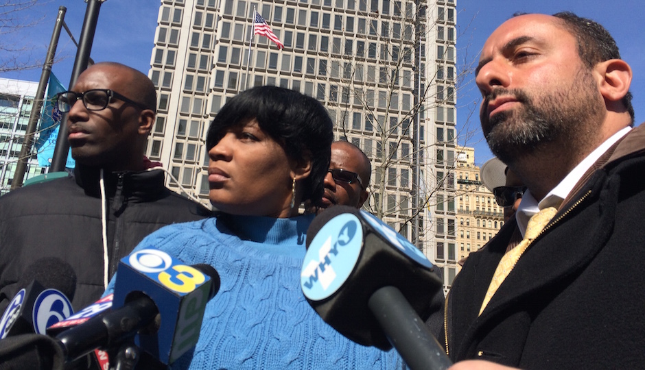 Tanya Brown-Dickerson, center, is flanked by Asa Khalif, left, and Brian Mildenberg, right, during a press conference in March. Dickerson’s son, Brandon Tate-Brown, was shot to death by police in December.
