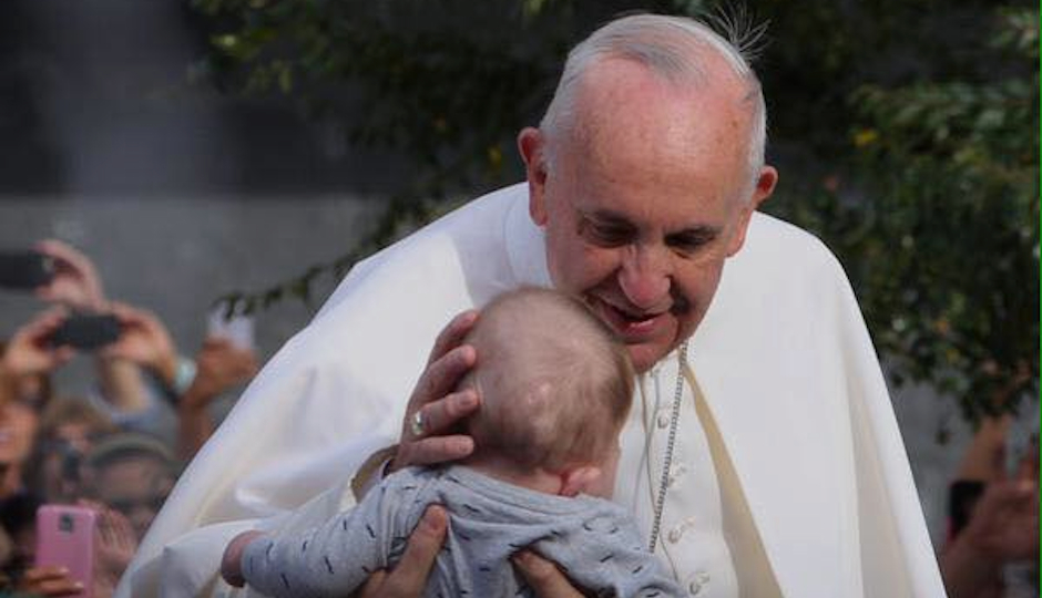 Pope Francis blesses baby  while in Philadelphia. 