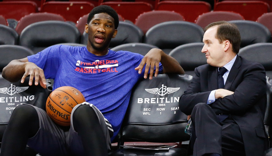 Sixers general manager Sam Hinkie talks with Joel Embiid before a game last season | Bill Streicher-USA TODAY Sports