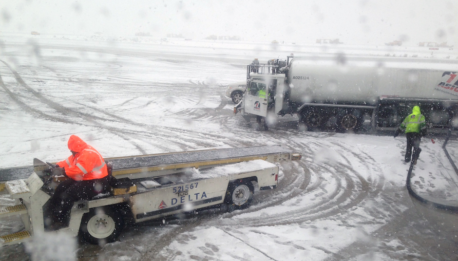 Airport baggage and fuel workers do their jobs as snow falls at Philadelphia International Airport on Thursday, March 5, 2015, in Philadelphia. (AP Photo/Oskar Garcia)