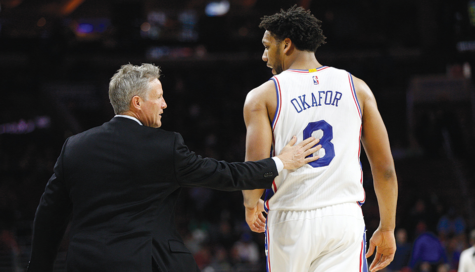 Coach Brett Brown talks mid-game with star center Jahlil Okafor. Photo courtesy of the Associated Press.
