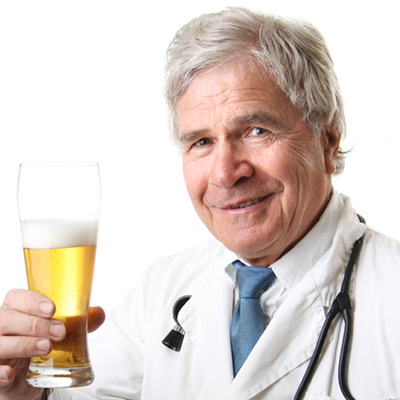 Ridiculous doctor with beer AleksandarNakic / iStock