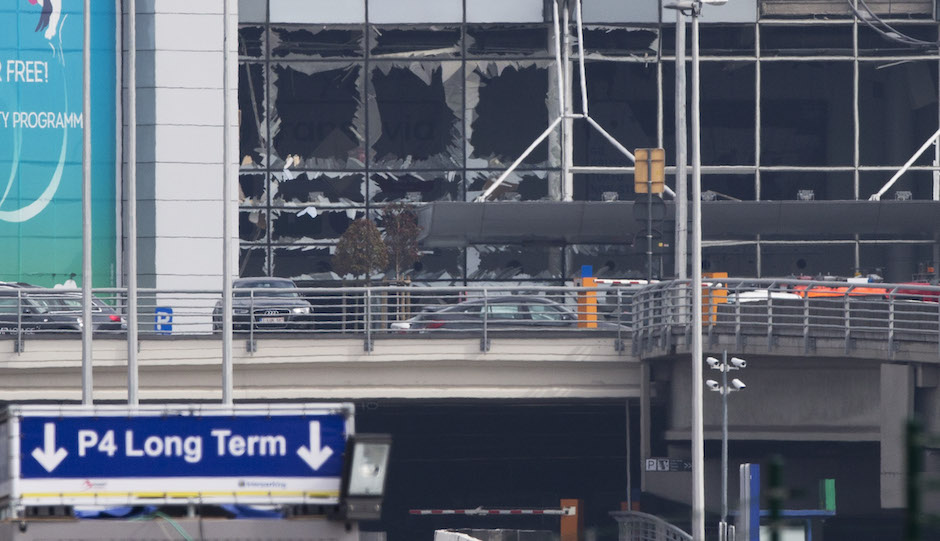 The blown out windows of Zaventem airport are seen after a deadly attack in Brussels, Belgium, Tuesday, March 22, 2016. Authorities in Europe have tightened security at airports, on subways, at the borders and on city streets after deadly attacks Tuesday on the Brussels airport and its subway system. (AP Photo/Peter Dejong)