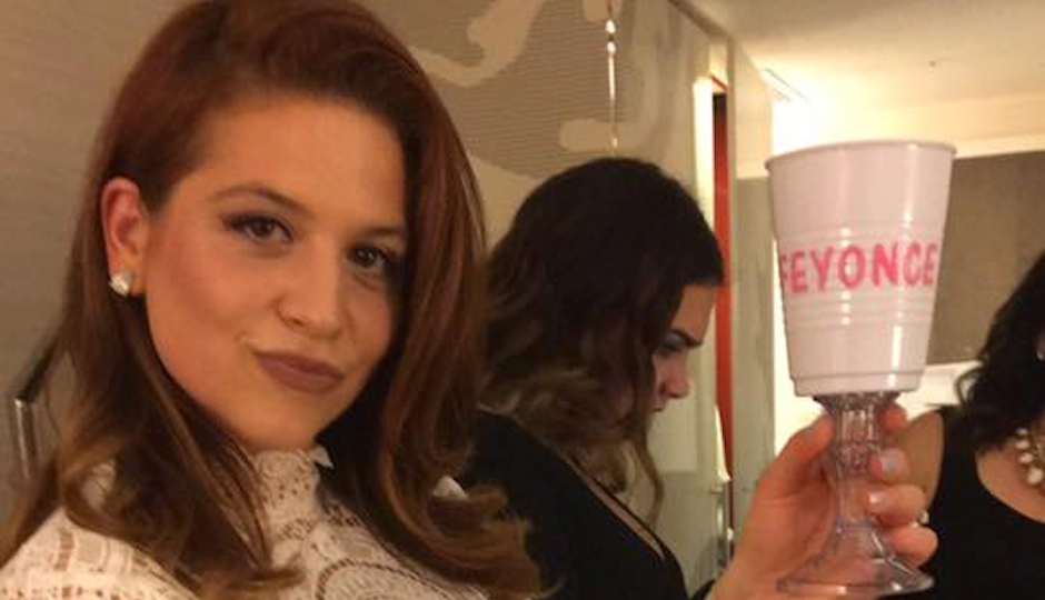 Port Richmond's Ginene MacMullen shows off her bachelorette party custom cup just hours before she says her party bus went up in flames.