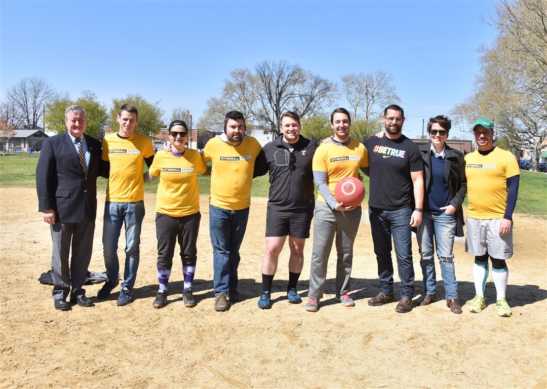 Mayor Jim Kenney, State Rep. Brian Sims, and Nellie Fitzpatrick photographed with members of Stonewall Sport's Kickball Team. Photography by Hugh E. Dillon. 