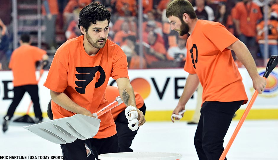 Members of the Philadelphia Flyers Ice Crew pick up wristbands that were thrown onto the ice during the third period against the Washington Capitals in game three of the first round of the 2016 Stanley Cup Playoffs at Wells Fargo Center.