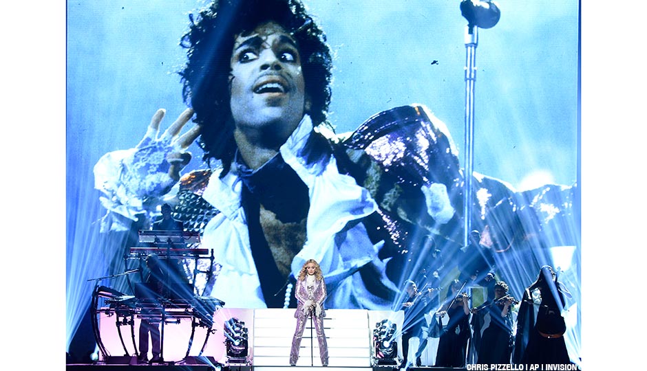 Madonna performs a tribute to Prince, pictured onscreen, at the Billboard Music Awards at the T-Mobile Arena on Sunday, May 22, 2016, in Las Vegas.