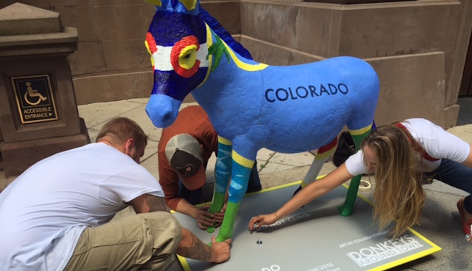 Workers unload a painted fiberglass donkey at the Union League on Broad Street