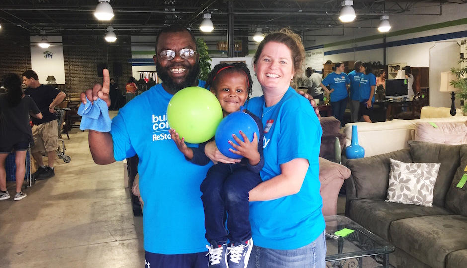 Habitat Associate Executive Director Corinne O'Connell with future homeowner Clifton Carter and his granddaughter Sahbriya at the ReStore Birthday Bash.