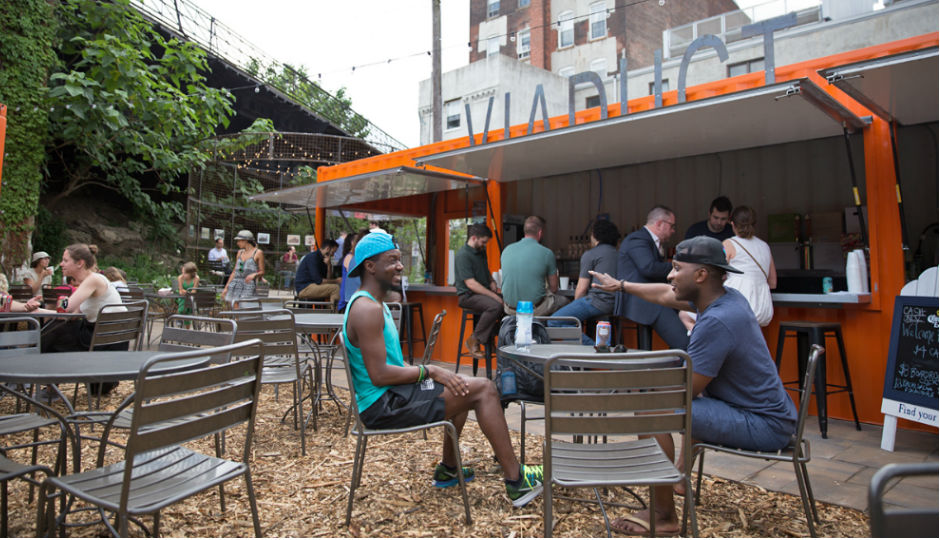 Patrons gather at the 2016 PHS pop-up garden at 10th and Hamilton Streets in Philadelphia's Callowhill District. PHS built the pop-up garden to bring awareness to the planned Rail Park. (Lindsay Lazarski/WHYY)