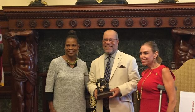 Kelly Lee, Jerry Pinkney, and Sheila Hess pose with the award that was presented to Pinkney this afternoon. 