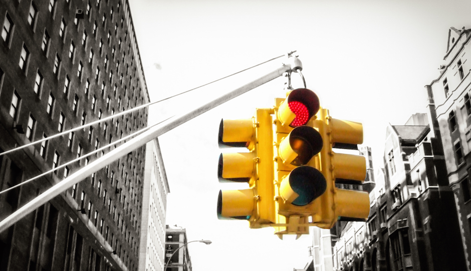 Yellow New York traffic light on red, with black and white background - colour pop
