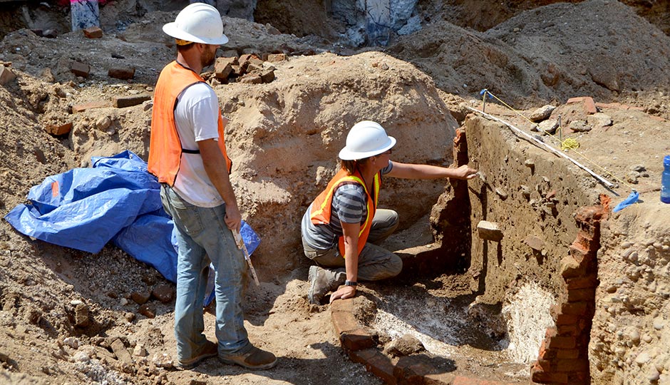 Archaeologists excavate a privy in Old City