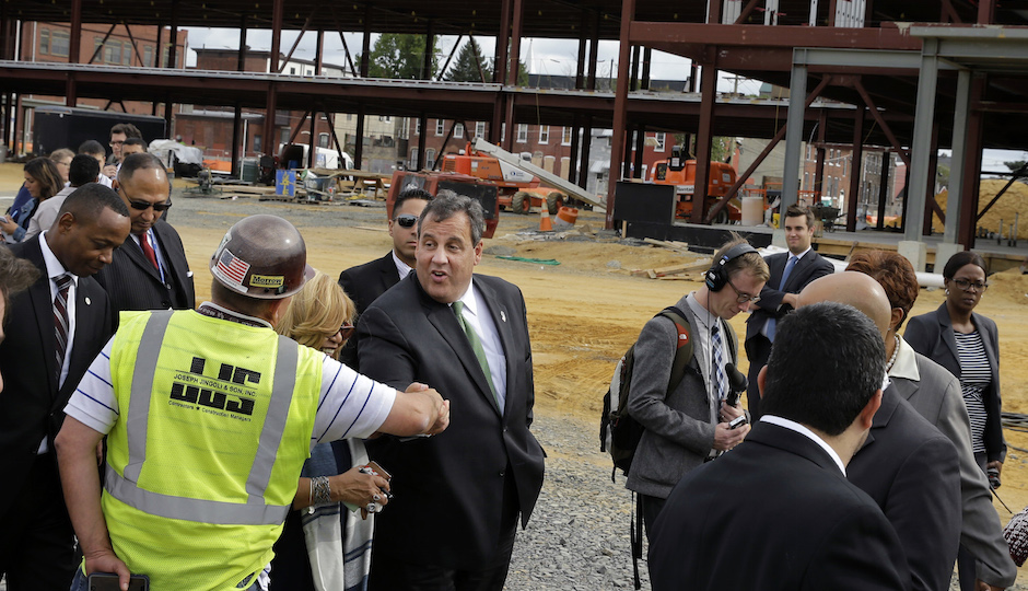 FILE In this Wednesday, Sept. 24, 2014 file photograph, Gov. Chris Christie, center, greets a worker at the construction of a huge new KIPP Cooper Norcross Academy school in Camden, N.J. Christie has made frequent stops in the high-crime city, stressing his efforts working with local Democratic lawmakers, including Mayor Dana Redd. Under his watch, there have been major changes to schools, policing and efforts to attract businesses. (AP Photo/Mel Evans,file)