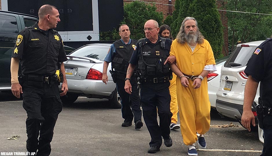 Lee Kaplan, front in yellow, and Daniel Stoltzfus, back in yellow, are led to a preliminary hearing Tuesday, Aug. 2, 2016, outside Bucks County Magisterial District Judge John I. Waltman's courtroom in Feasterville, Pa. Daniel Stoltzfus and his wife Savilla Stoltzfus were ordered to stand trial on charges they gave away their 14-year-old daughter to a Philadelphia-area man after he helped them out financially.