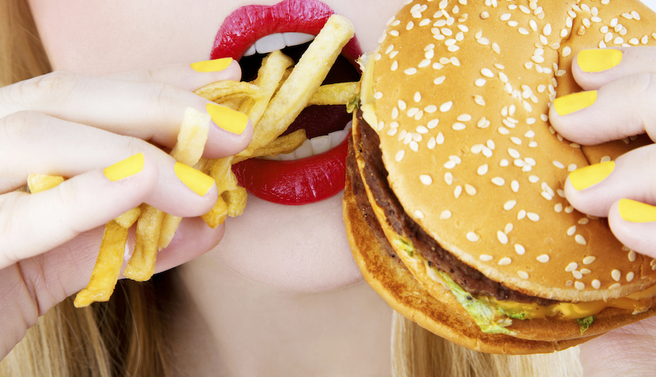 close-up of red lips eating junk food