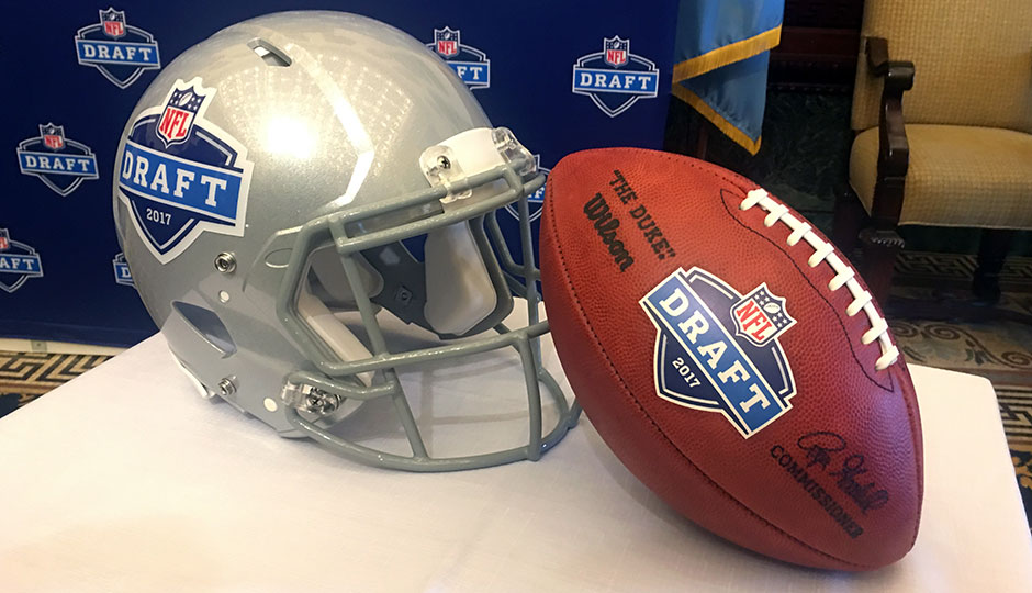 A grey NFL Draft helmet and a football