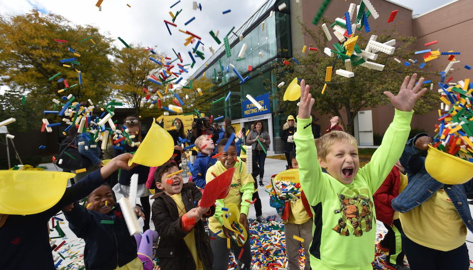 Plymouth Elementary School first grade students celebrate the groundbreaking of the new Legoland Discovery Center at Plymouth Meeting Mall by playing in a pile of more than 50,000 Lego bricks spilled by a dump truck at the Oct. 25 ceremony. | Photo courtesy Legoland Discovery Center