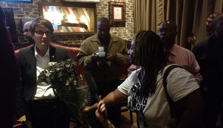 Nellie Fitzpatrick being offered "anti-blackness" flowers by protesters on October 5th. Photo by Ernest Owens.